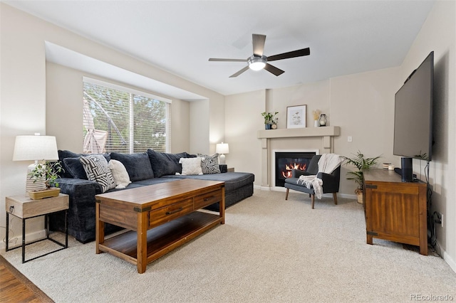 2763 Dharma Ave, Broomfield, CO 80020 - living area featuring a ceiling fan, a glass covered fireplace, and light colored carpet