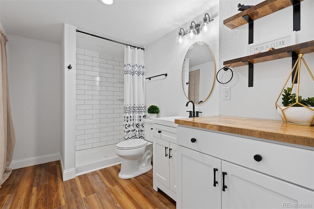 2763 Dharma Ave, Broomfield, CO 80020 - bathroom featuring vanity, a tile shower, and wood finished floors