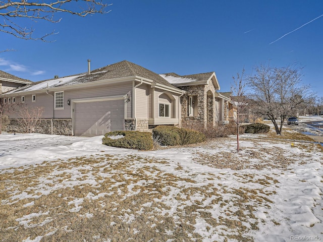 view of snow covered exterior with a garage