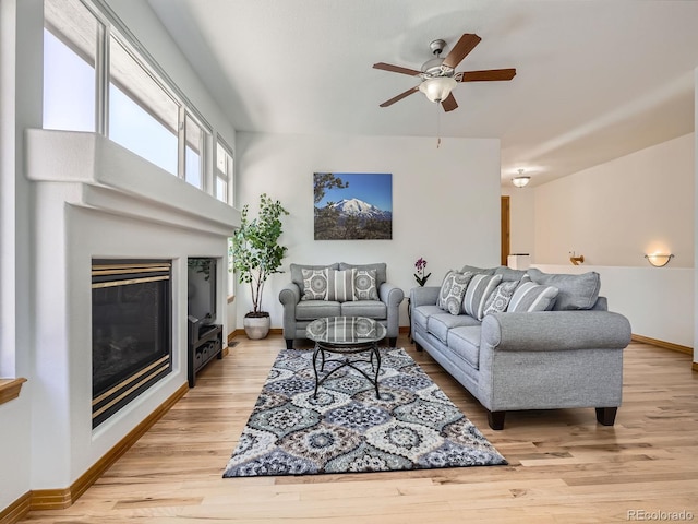 living room with ceiling fan and light wood-type flooring