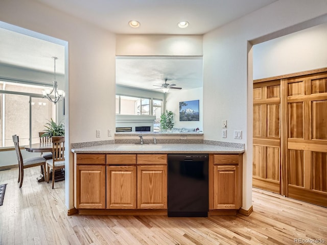 kitchen with sink, ceiling fan with notable chandelier, dishwasher, and light wood-type flooring