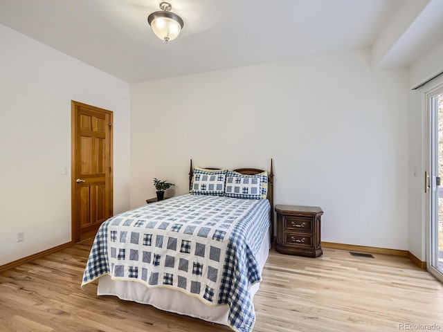 bedroom with access to exterior and light hardwood / wood-style floors