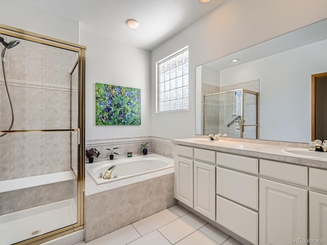 bathroom featuring vanity, shower with separate bathtub, and tile patterned flooring