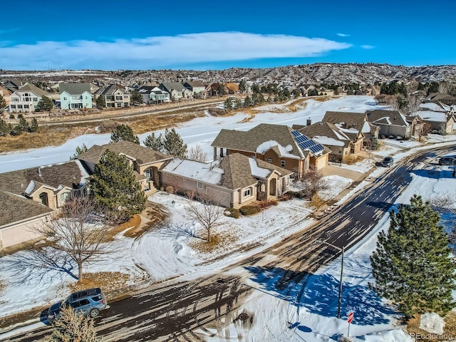 snowy aerial view with a mountain view