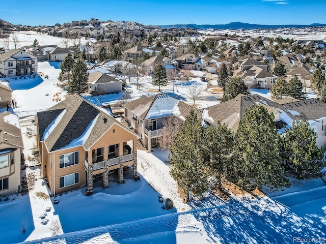 snowy aerial view featuring a mountain view