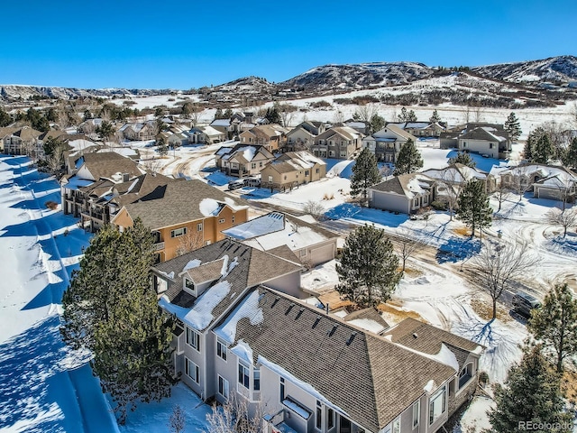 snowy aerial view with a mountain view