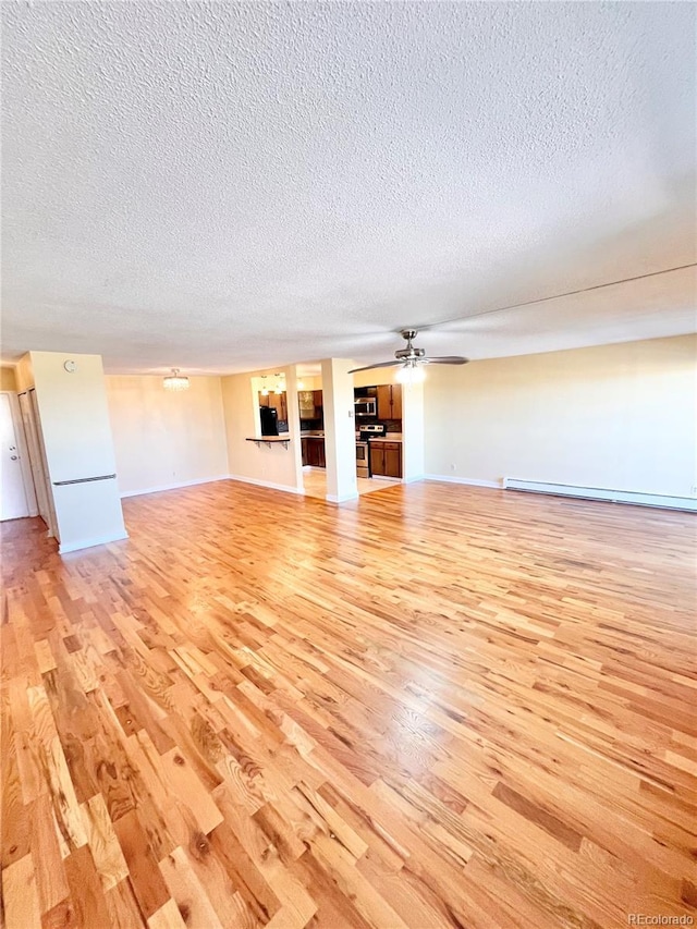 unfurnished living room with ceiling fan, a baseboard radiator, a textured ceiling, and light wood-type flooring