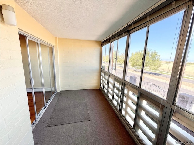 unfurnished sunroom with baseboard heating