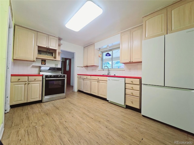 kitchen with sink, white appliances, light hardwood / wood-style flooring, and backsplash