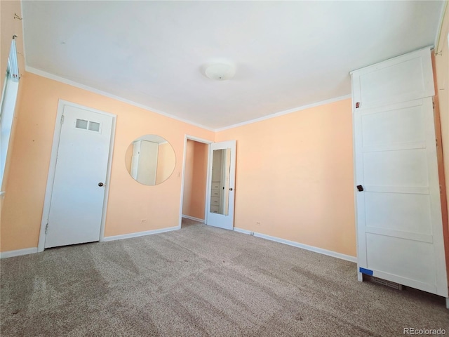 unfurnished room with crown molding and carpet floors