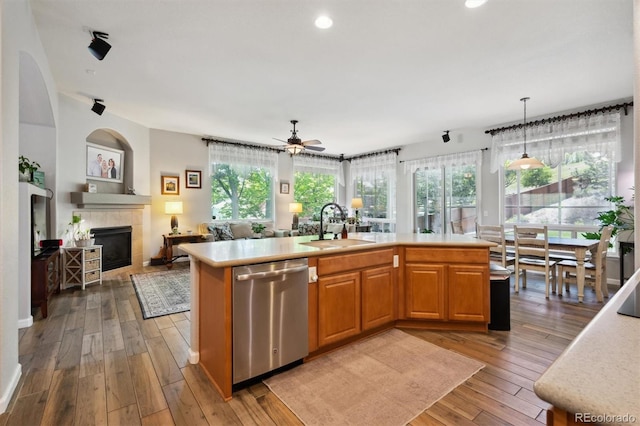 1488 Baguette Dr, Castle Rock, CO 80108 - kitchen featuring stainless steel dishwasher, open floor plan, a sink, light countertops, and light wood-type flooring