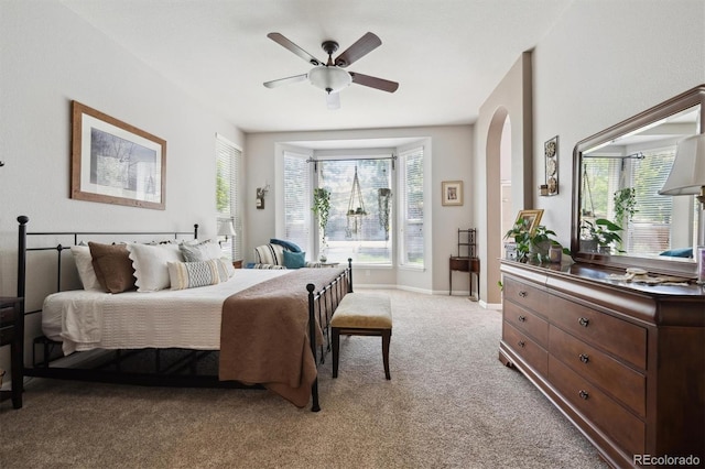 1488 Baguette Dr, Castle Rock, CO 80108 - bedroom featuring light colored carpet, arched walkways, ceiling fan, and baseboards