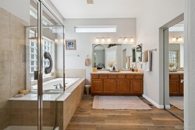 1488 Baguette Dr, Castle Rock, CO 80108 - bathroom featuring wood finished floors, a bath, vanity, and a shower stall