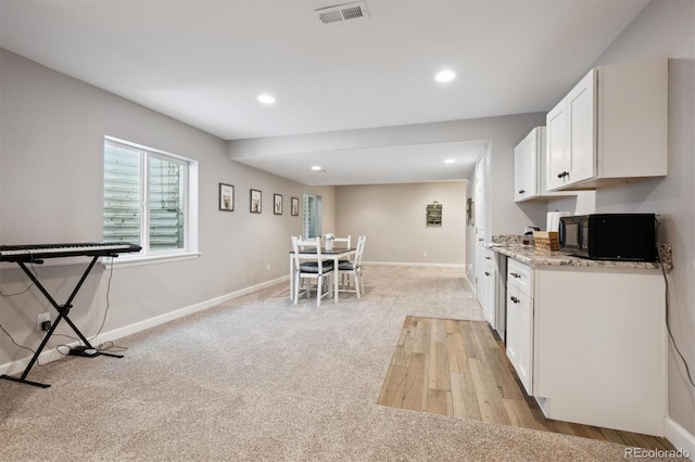 1488 Baguette Dr, Castle Rock, CO 80108 - kitchen featuring black microwave, light carpet, white cabinetry, recessed lighting, and baseboards