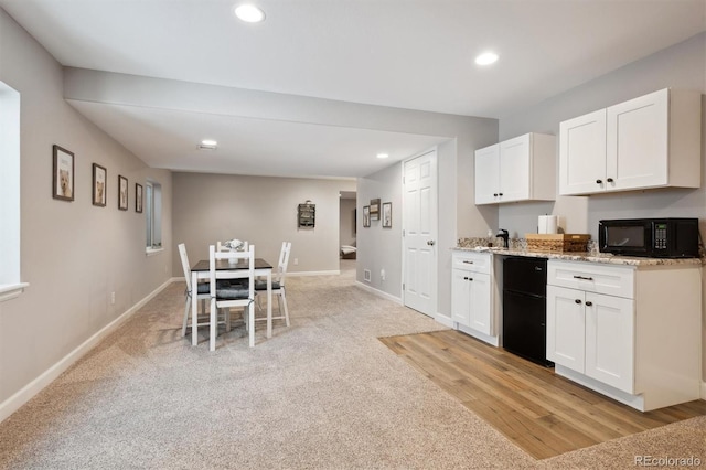 1488 Baguette Dr, Castle Rock, CO 80108 - kitchen with black microwave, white cabinetry, recessed lighting, light stone counters, and dishwasher