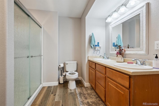1488 Baguette Dr, Castle Rock, CO 80108 - full bath featuring wood finished floors, toilet, a shower stall, double vanity, and baseboards