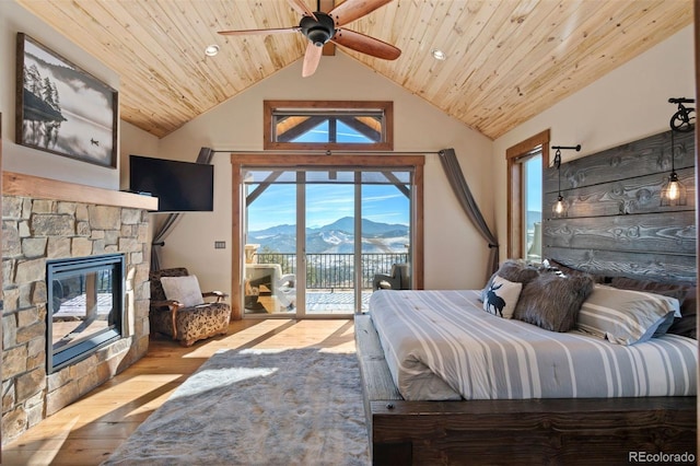 bedroom featuring access to exterior, light wood-type flooring, wood ceiling, a fireplace, and lofted ceiling