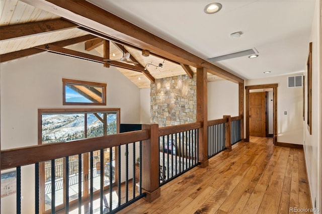 hallway featuring vaulted ceiling with beams and light hardwood / wood-style flooring