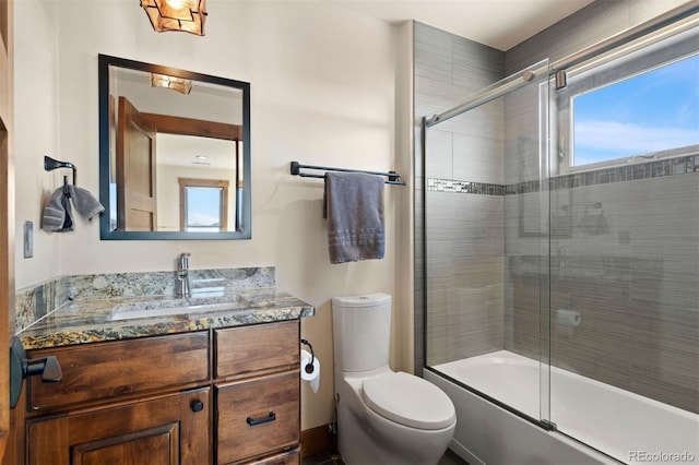 full bathroom featuring vanity, toilet, and enclosed tub / shower combo