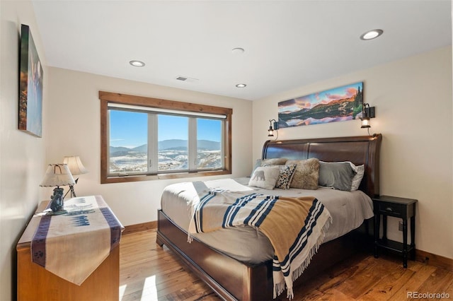 bedroom featuring a mountain view and wood-type flooring