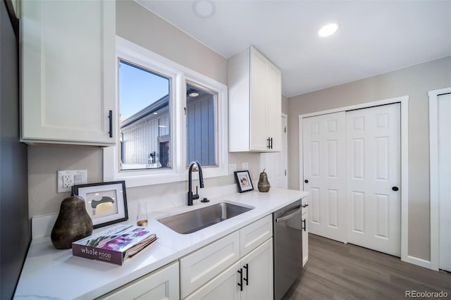 kitchen featuring white cabinetry, dishwasher, sink, and dark hardwood / wood-style floors