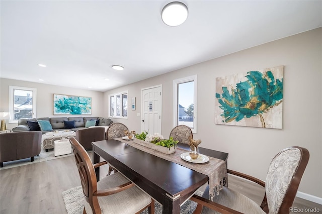 dining space with wood-type flooring