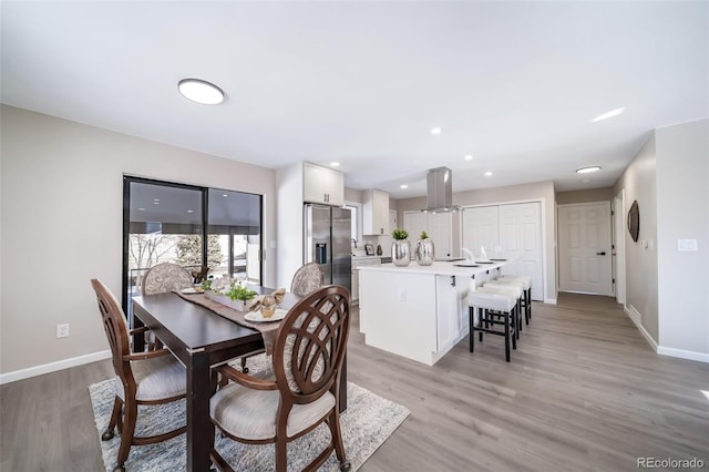 dining space with light wood-type flooring