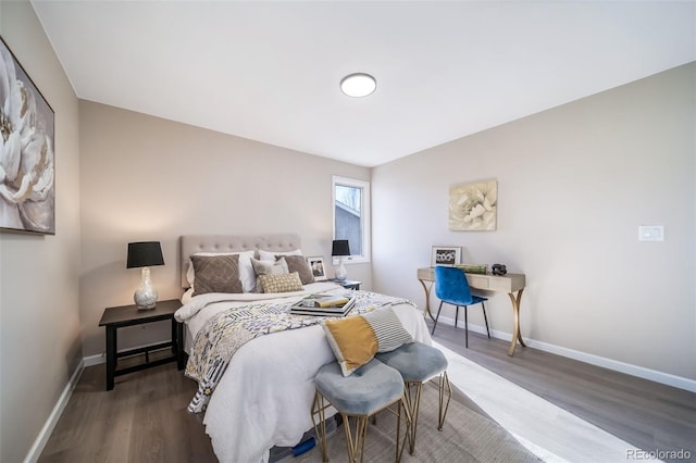 bedroom with dark hardwood / wood-style floors