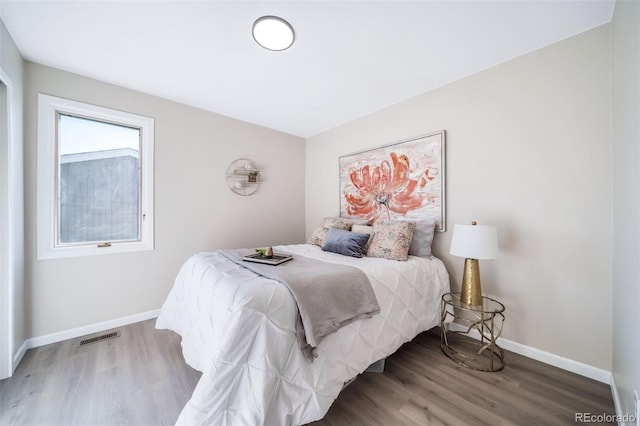 bedroom with hardwood / wood-style floors