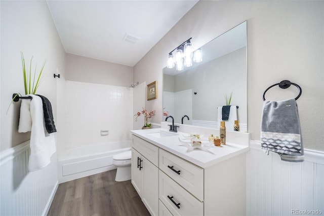 full bathroom featuring vanity, hardwood / wood-style floors,  shower combination, and toilet