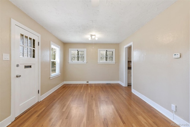 924 E Saint Vrain St, Colorado Springs, CO 80903 - unfurnished dining area featuring light wood-type flooring, baseboards, and a textured ceiling