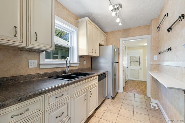 924 E Saint Vrain St, Colorado Springs, CO 80903 - kitchen with a sink, dishwasher, dark countertops, light tile patterned flooring, and tasteful backsplash