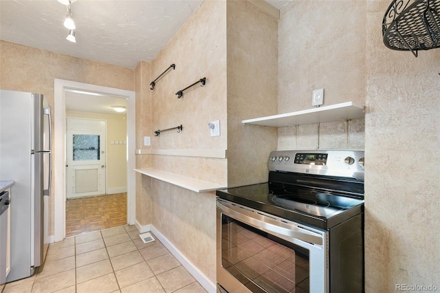 924 E Saint Vrain St, Colorado Springs, CO 80903 - kitchen featuring appliances with stainless steel finishes, light countertops, light tile patterned flooring, and baseboards