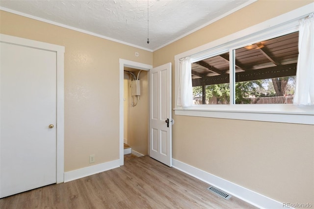 924 E Saint Vrain St, Colorado Springs, CO 80903 - unfurnished bedroom featuring wood finished floors, baseboards, ornamental molding, and a textured ceiling