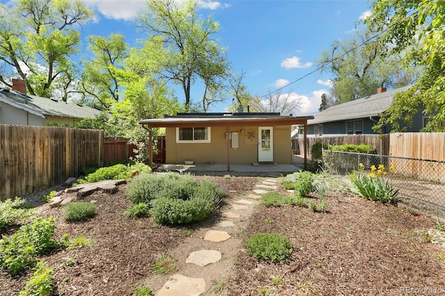 924 E Saint Vrain St, Colorado Springs, CO 80903 - back of property with a fenced backyard, a patio area, and stucco siding