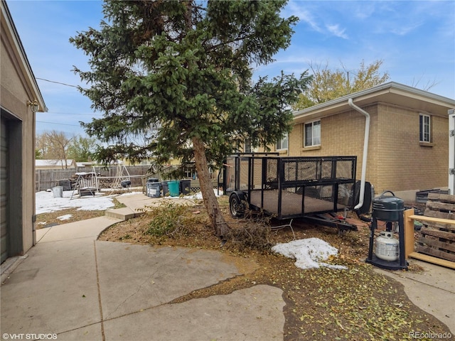 300 S Simms St, Lakewood, CO 80228 - view of home's exterior featuring brick siding and a patio area