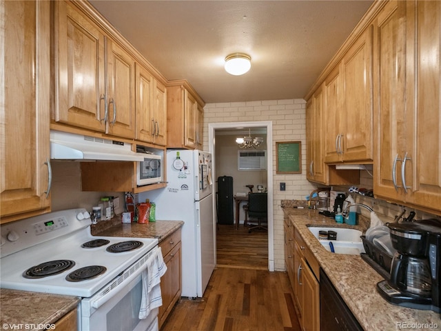 kitchen featuring dark wood-type flooring, an inviting chandelier, sink, light stone countertops, and white appliances