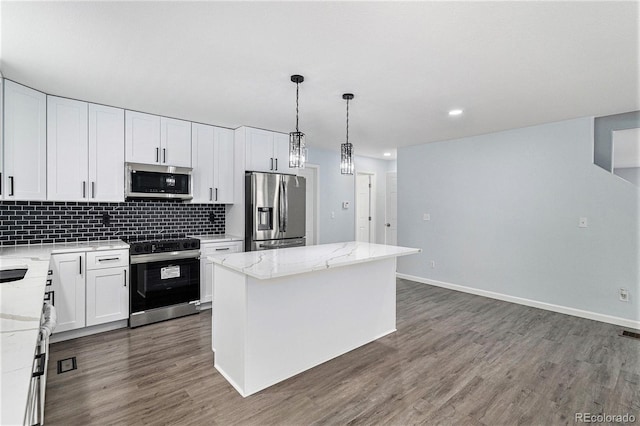 1963 Hogan Ct, Castle Rock, CO 80109 - kitchen featuring stainless steel appliances, a kitchen island, dark wood-style floors, tasteful backsplash, and recessed lighting