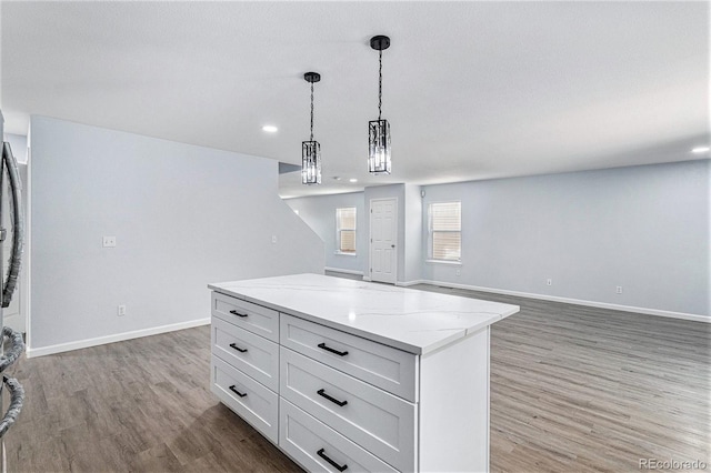 1963 Hogan Ct, Castle Rock, CO 80109 - kitchen featuring light wood-style flooring, decorative light fixtures, a kitchen island, open floor plan, and recessed lighting