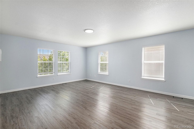 1963 Hogan Ct, Castle Rock, CO 80109 - spare room with dark wood-style flooring, baseboards, and a textured ceiling