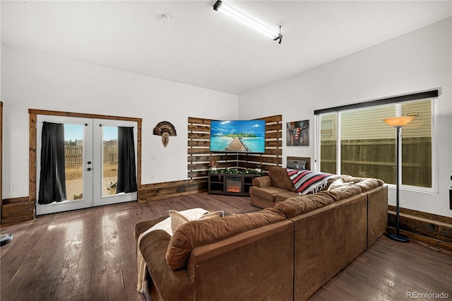 living room with a fireplace, french doors, and wood-type flooring