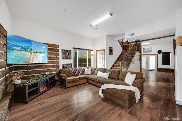 living room featuring a textured ceiling and dark wood-type flooring