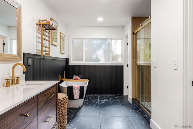 bathroom with vanity and independent shower and bath