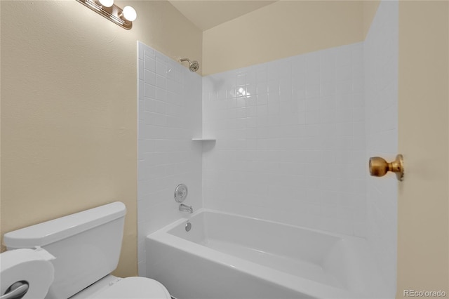 bathroom featuring tiled shower / bath and toilet