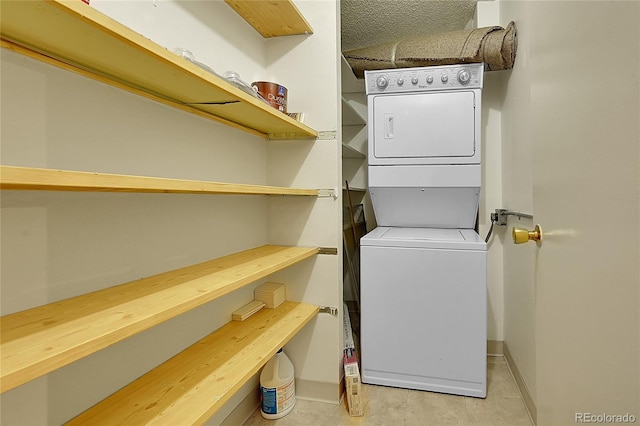 laundry area with stacked washer and clothes dryer