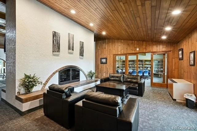 carpeted living room featuring french doors, vaulted ceiling, wood ceiling, and wood walls