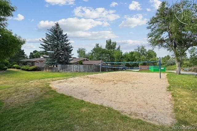 surrounding community featuring volleyball court and a lawn