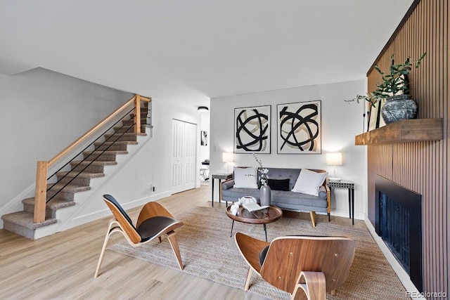 5667 S Lowell Blvd, Littleton, CO 80123 - living area with stairs, wood finished floors, a fireplace, and baseboards