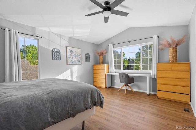 1464 Spotted Owl Way, Highlands Ranch, CO 80129 - bedroom featuring vaulted ceiling, multiple windows, wood finished floors, and a ceiling fan