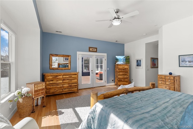 bedroom with visible vents, ceiling fan, wood finished floors, access to exterior, and french doors